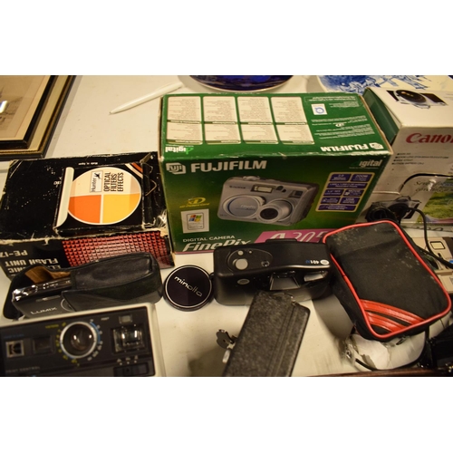 5K - A mixed collection of cameras and accessories to include Kodak, Canon, JVC etc

Condition is mixed. ... 