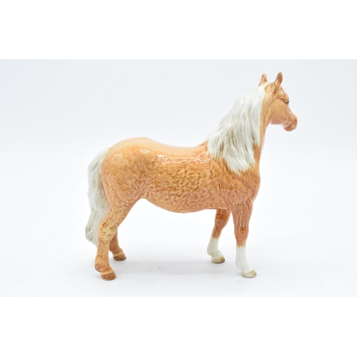 151 - Beswick Pinto pony in Palomino colourway 1373. 17cm tall. In good condition with no obvious damage o... 