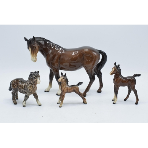 144 - A collection of brown Beswick horses and foals to include mare facing left 976, early Shetland foal,... 