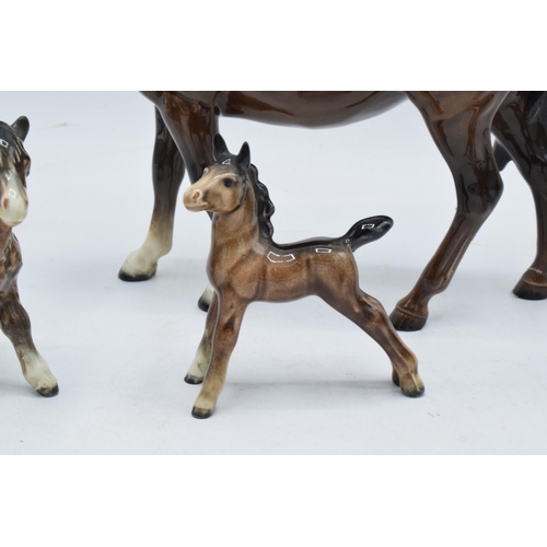 144 - A collection of brown Beswick horses and foals to include mare facing left 976, early Shetland foal,... 