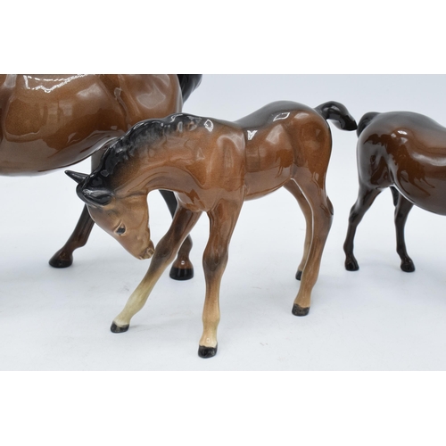 145 - A trio of brown Beswick horses to include leg tucked horse 1549, mare facing right 991 and a large s... 