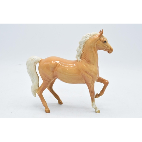 153 - Beswick palomino prancing Arab horse 1261. 17cm tall. In good condition with no obvious damage or re... 