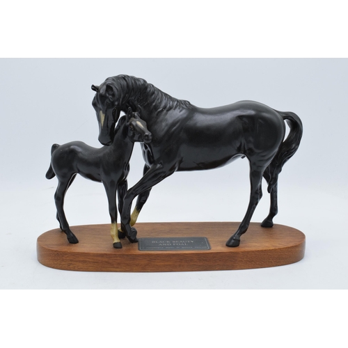 155A - Beswick Black Beauty and Foal on wooden base. In good condition no obvious damage or restoration.
