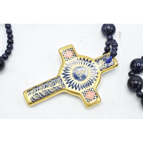 178 - Royal Crown Derby Imari Rosary Cross pendant set on a blue beaded necklace, complete with box. As ne... 