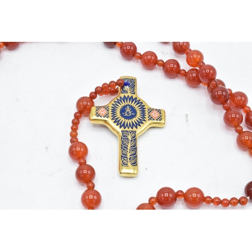 179 - Royal Crown Derby Imari Rosary Cross pendant set on an orange-beaded necklace, complete with box. As... 