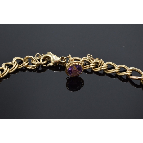203 - 9ct gold bracelet set with amethyst stones. 24.6 grams. Approximate length 25cm.