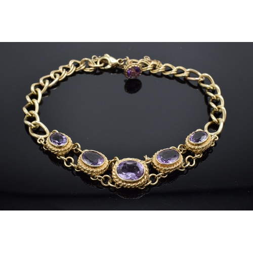 203 - 9ct gold bracelet set with amethyst stones. 24.6 grams. Approximate length 25cm.