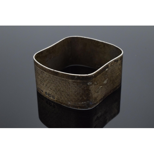 205 - A pair of silver napkin rings, one circular Birmingham 1954 and a square example Birmingham 1928. 42... 