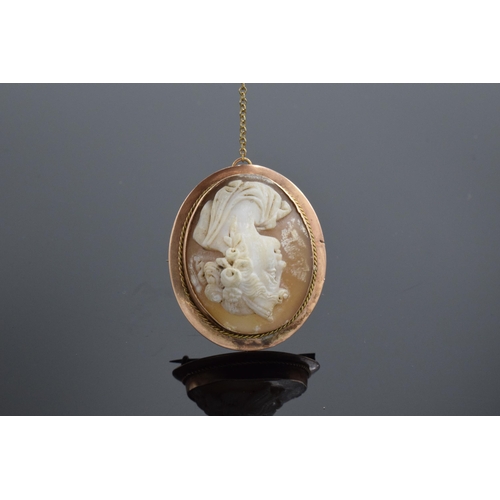 207 - 9ct gold carved shell cameo with gold safety chain. 7.6 grams.