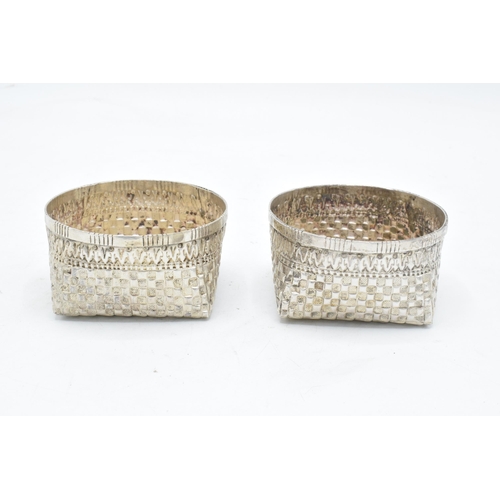 210 - A pair of foreign silver bon bon dishes with patchwork decoration. Tested as low grade silver. 105.4... 