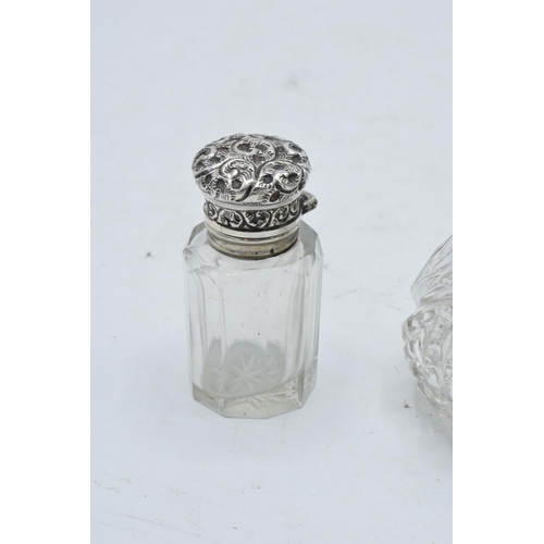 222 - A silver topped scent bottle with a stopper (Birmingham 1910) together with a sterling silver topped... 