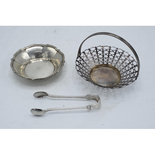 226 - A collection of silver items to include a pair of tongs Sheffield 1924, a silver dish Birmingham 192... 