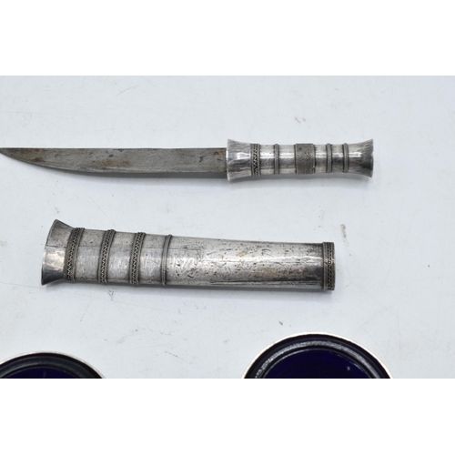 228 - A Middle Eastern silver cased fruit knife together with a pair of salts (3).