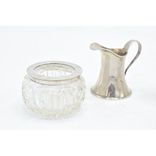 231 - A collection of silver items to include a pair of silver topped salts (London 1900), a miniature cre... 