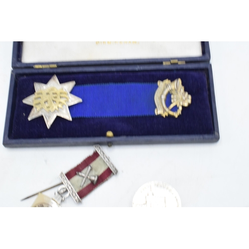 238 - A cased silver attendance medal together with a George V commemorative coin and a Masonic type jewel... 