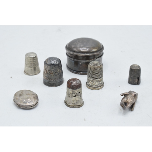 247 - A collection of silver items to include a round pillbox, a locket, a silver thimble and other exampl... 