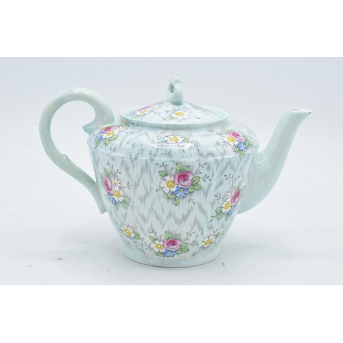 69 - Paragon Fine China teapot with floral decoration on a light blue / duck egg green background. In goo... 