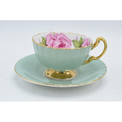84 - A collection of Aynsley cups and saucers to include a pink rose / cabbage rose example, a similar bl... 