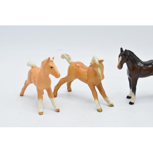148D - A collection of Beswick foals to include palomino examples and a brown example (5). In good conditio... 