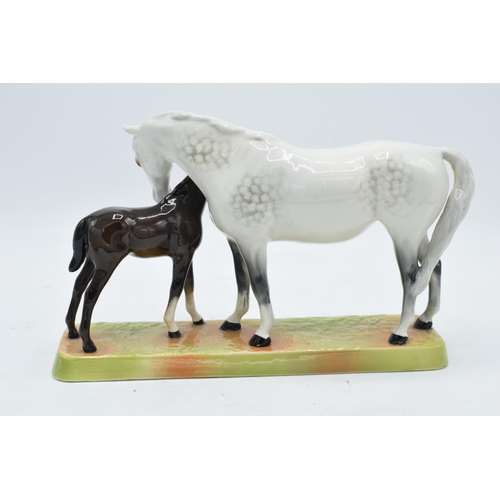 148N - Beswick Mare and Foal - grey mare with dark brown foal on ceramic grass base 1811. In good condition... 