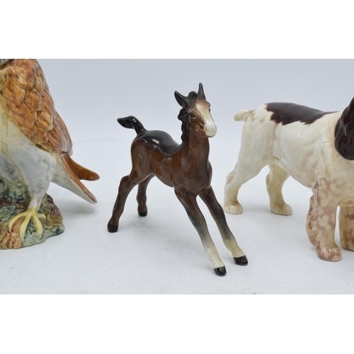 110 - A trio of Beswick animals to include barn owl 1046, large brown outstretched foal and cocker spaniel... 