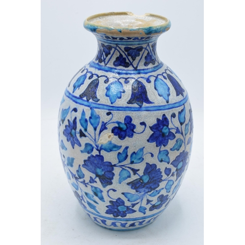 198 - A 19th century blue and white pottery Iznik or similar vase with crackle glaze effect. 25cm tall.