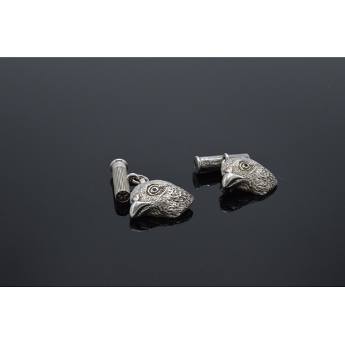 210L - A pair of hallmarked silver cufflinks in the form of grouse heads set with blue sapphires for eyes w... 