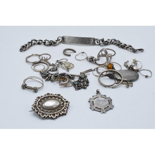 221 - A collection of silver and silver-coloured jewellery to include an ID bracelet, silver brooch, rings... 