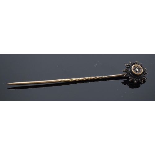 241 - 15ct gold stick pin set with a diamond, 5.5cm long.