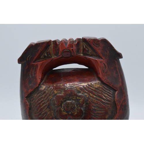 308 - Carved antique wooden Tibetan cow bell, 20.5cm tall.