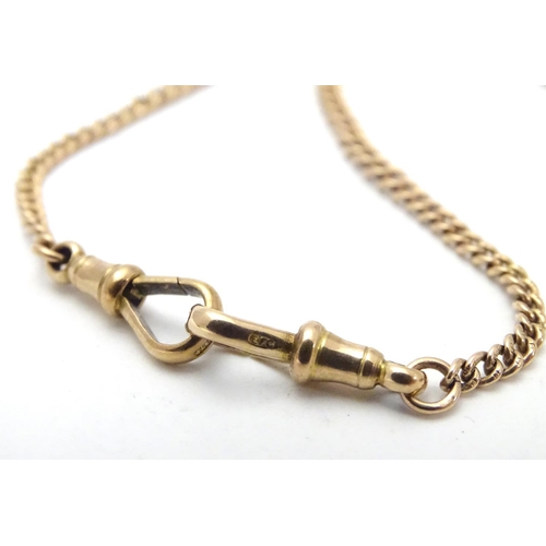 562 - A 9ct gold Albert watch chain (approx 16g) with gilt metal barrel formed fob