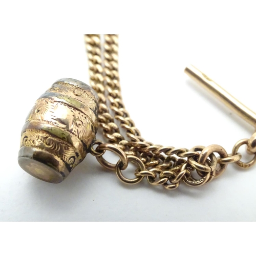 562 - A 9ct gold Albert watch chain (approx 16g) with gilt metal barrel formed fob