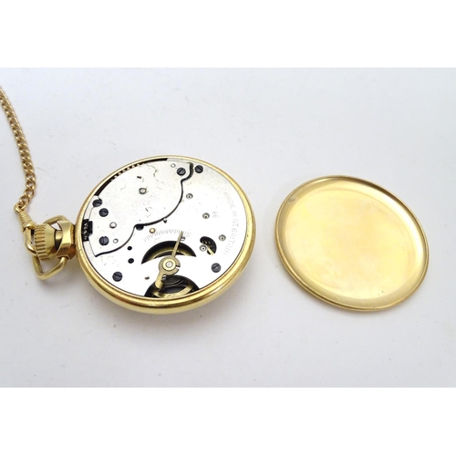 564 - An Ingersoll gold plated open faced pocket watch on gold plated watch chain. White enamel dial with ... 