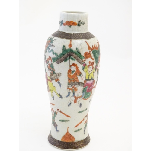 9 - A Japanese crackle glaze vase decorated in famille verte with warriors and horses. Character marks t... 
