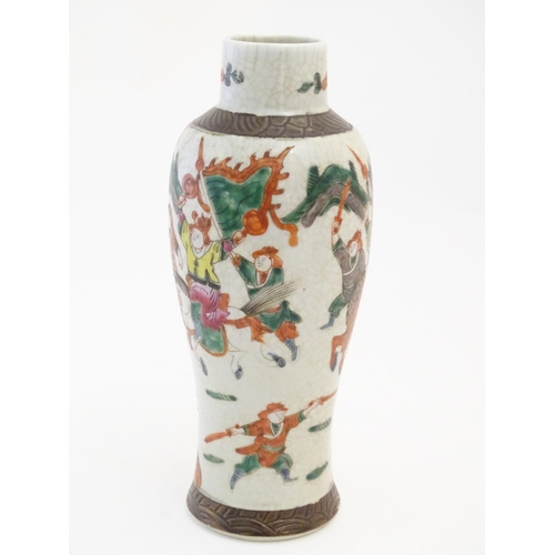 9 - A Japanese crackle glaze vase decorated in famille verte with warriors and horses. Character marks t... 
