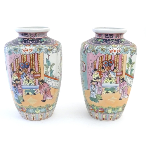 19 - A pair of Oriental vases with panelled decoration depicting an interior scene with an Imperial figur... 