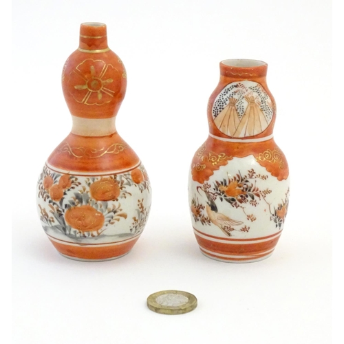 20 - Two Japanese Kutani vases with floral, foliate and bird detail with gilt highlights. Character marks... 
