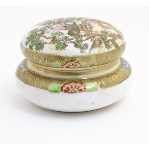 28 - A Japanese Noritake circular pot and cover with hand painted decoration depicting a Geisha girl in a... 