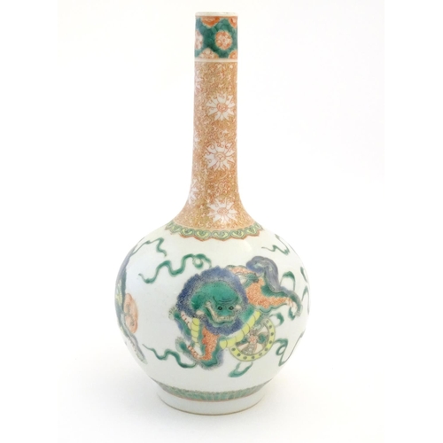 38 - A Chinese bottle vase decorated with stylised foo dogs / dragons. The neck with floral and foliate d... 