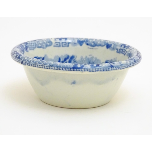 40 - A 19thC blue and white small strainer, decorated with an Oriental landscape scene with pagodas etc. ... 
