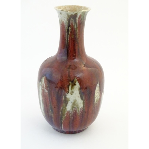1 - An Oriental high fired sang de boeuf baluster vase. Approx. 12
