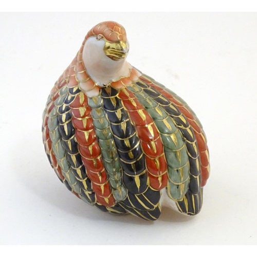 11 - A Chinese model of a quail bird with gilt highlights. Marked under. Approx. 5 1/2