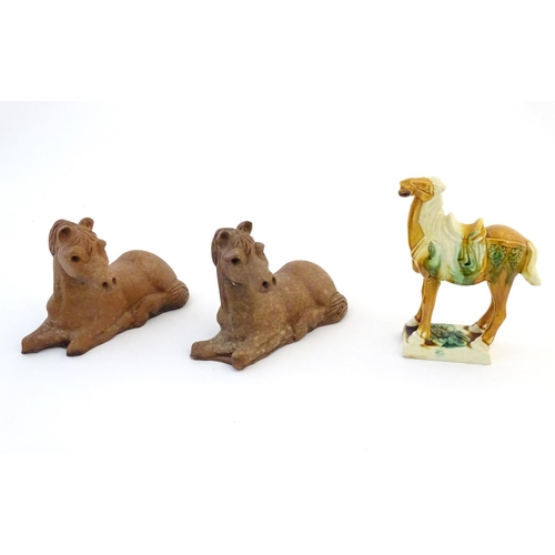21 - Two Oriental terracotta models of horses, together with a Chinese model of a Tang style horse. Large... 