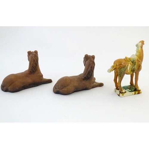 21 - Two Oriental terracotta models of horses, together with a Chinese model of a Tang style horse. Large... 