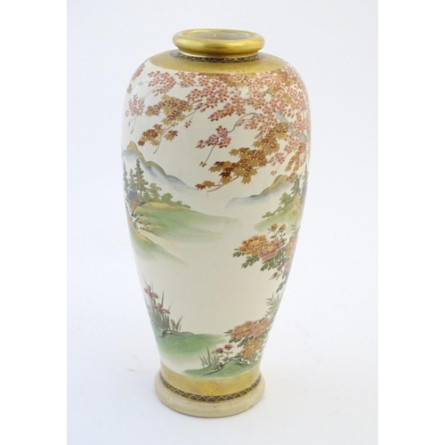 24 - A Japanese vase decorated with a landscape scene with mountains, waterfalls, birds, pagodas, flowers... 
