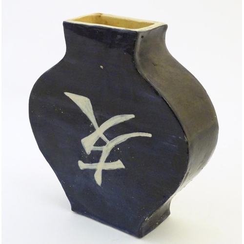 47 - An Oriental slab vase with stylised character mark detail, possibly Japanese. Approx. 10 1/4