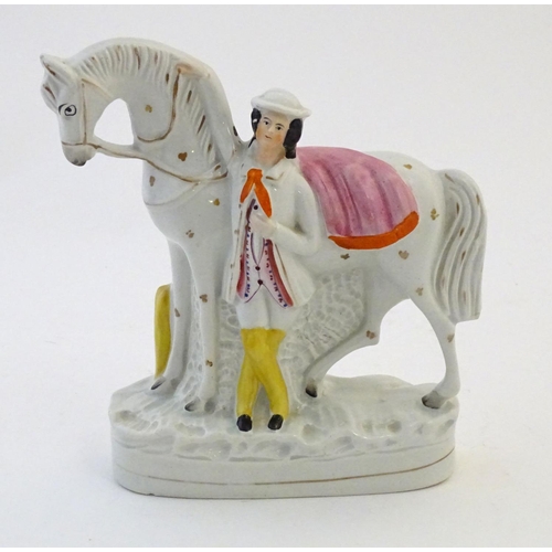 51 - A Staffordshire pottery flat back model depicting a man and a horse. Approx. 9