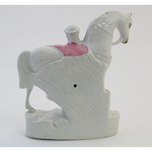 51 - A Staffordshire pottery flat back model depicting a man and a horse. Approx. 9