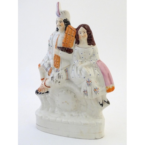 53 - A Staffordshire flat back figural group depicting a Scottish highland couple with clock detail below... 