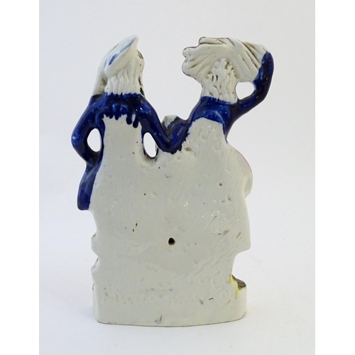 58 - A Staffordshire pottery flat back figural group depicting a harvest couple, the man carries a flagon... 